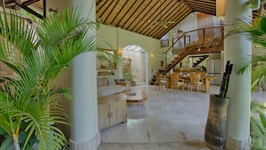A spacious interior with a high ceiling, a staircase, and multiple seating areas. - Mayana Villas (Canggu)