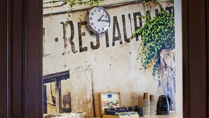 A rustic wall with a clock and the word "RESTAURANT" partially visible. - Boutique Hostel (Lodz)