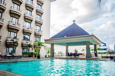 Outdoor pool, pool loungers. Mega Anggrek Hotel & Convention