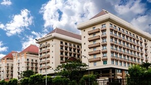 A multi-story hotel with a classic architectural design, featuring balconies and a prominent entrance. - Mega Anggrek Hotel & Convention (Jakarta)