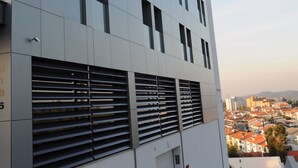 A modern building with a flat facade, large windows, and a staircase leading to an entrance. - Hotel Portas de Santa Rita (Valongo)