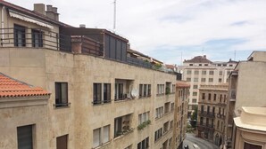 A multi-story building with a central courtyard, featuring balconies and a mix of architectural styles.