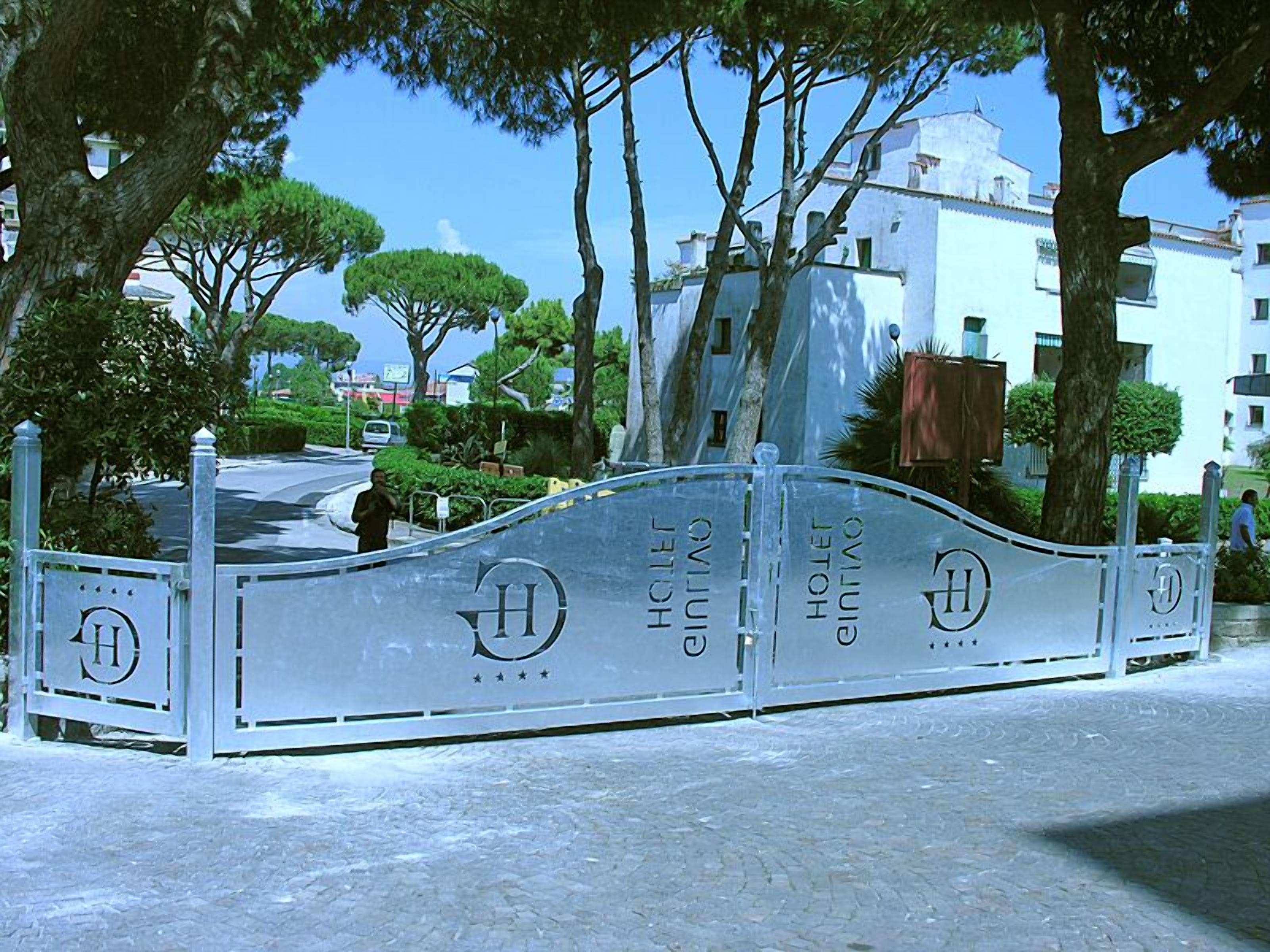 A gated entrance to a hotel with a clear view of the surrounding trees and buildings.