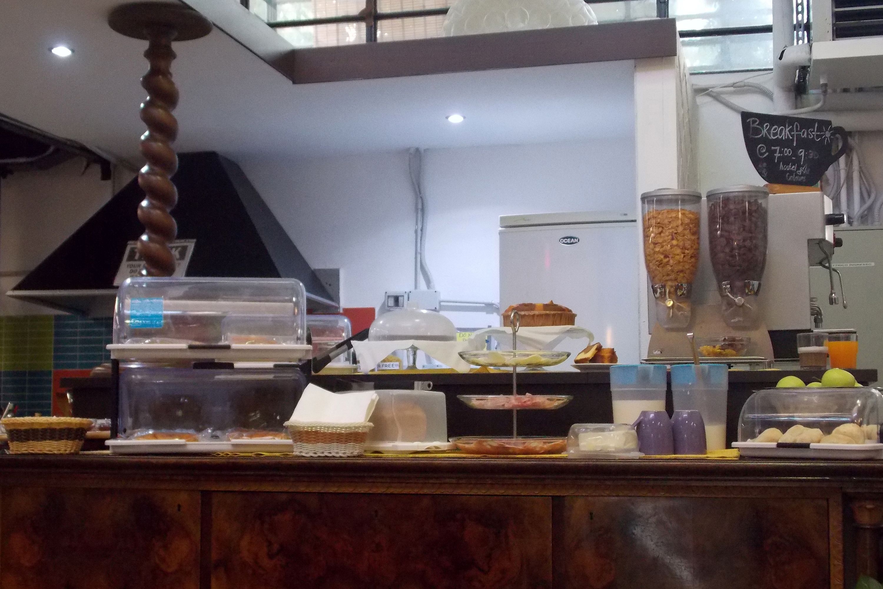 A breakfast counter with various food items and a coffee machine.
