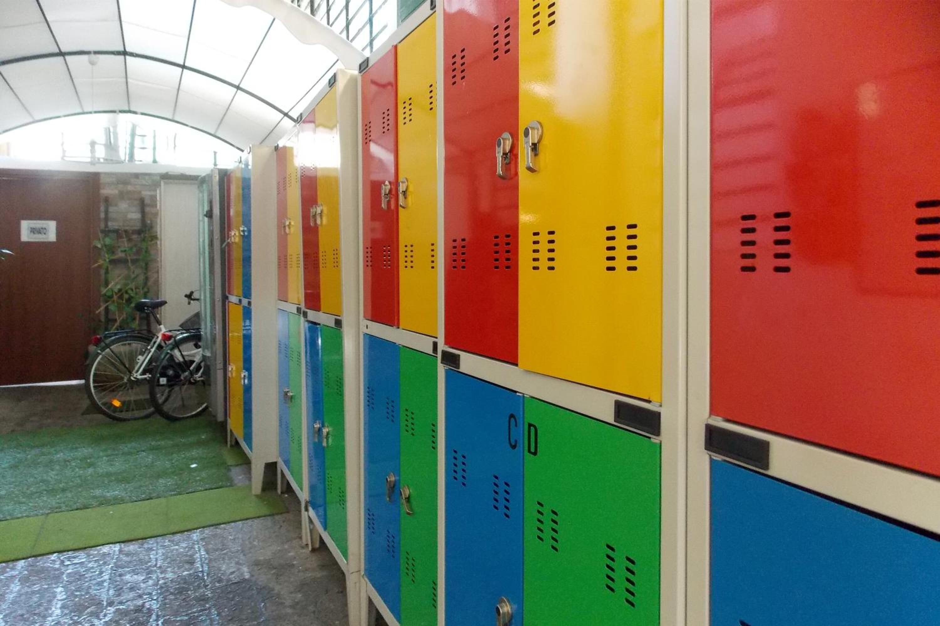 A row of lockers with a bicycle parked outside.