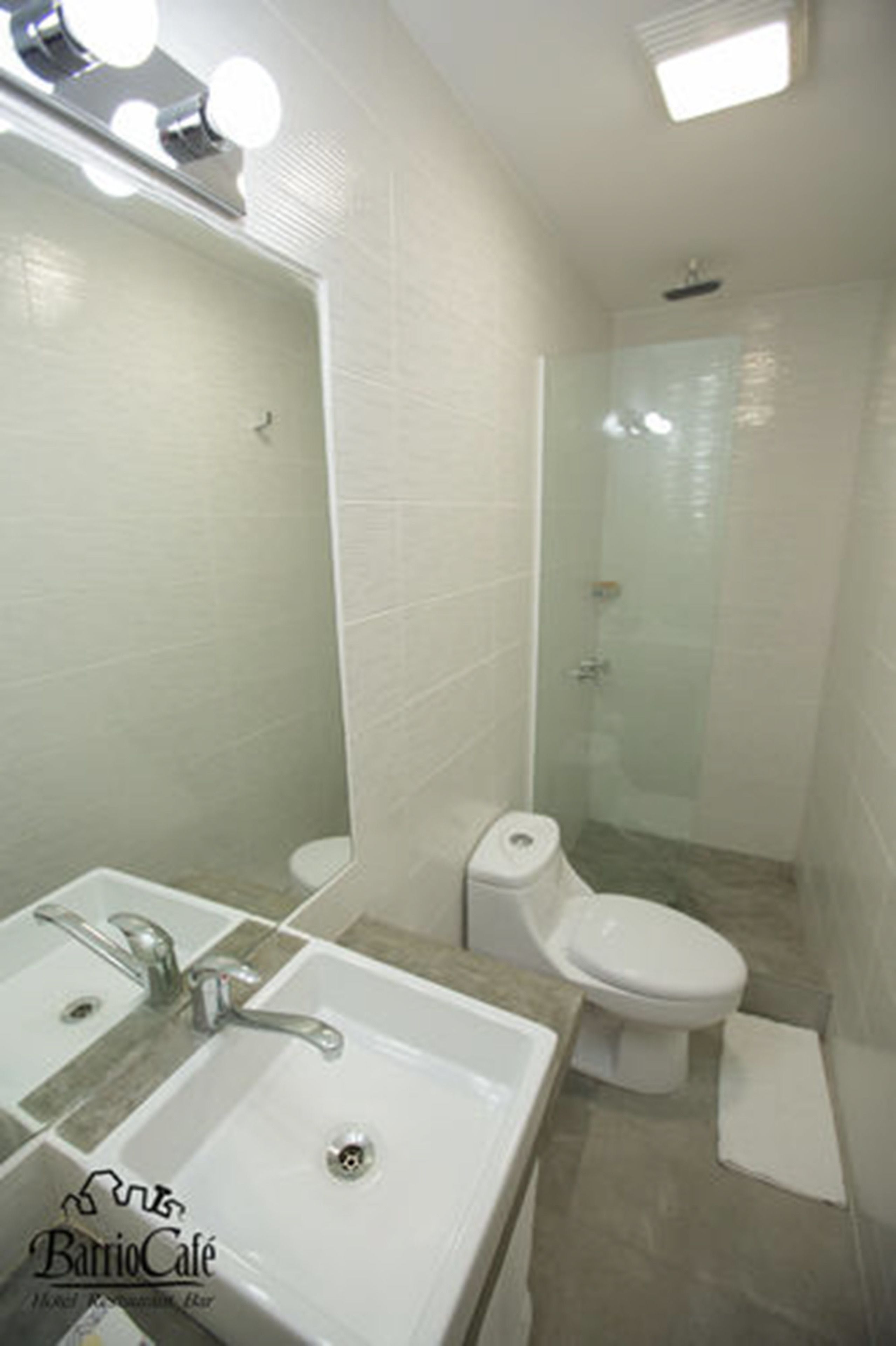 A bathroom with a sink, mirror, and toilet.