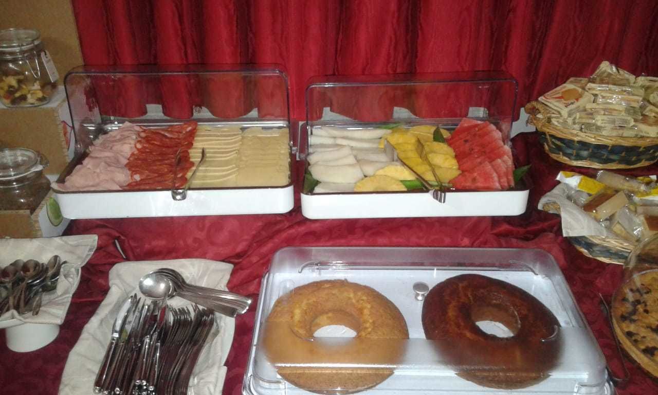 A buffet setup with various food items and utensils.