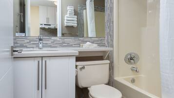 A bathroom with a toilet, sink, and bathtub.
