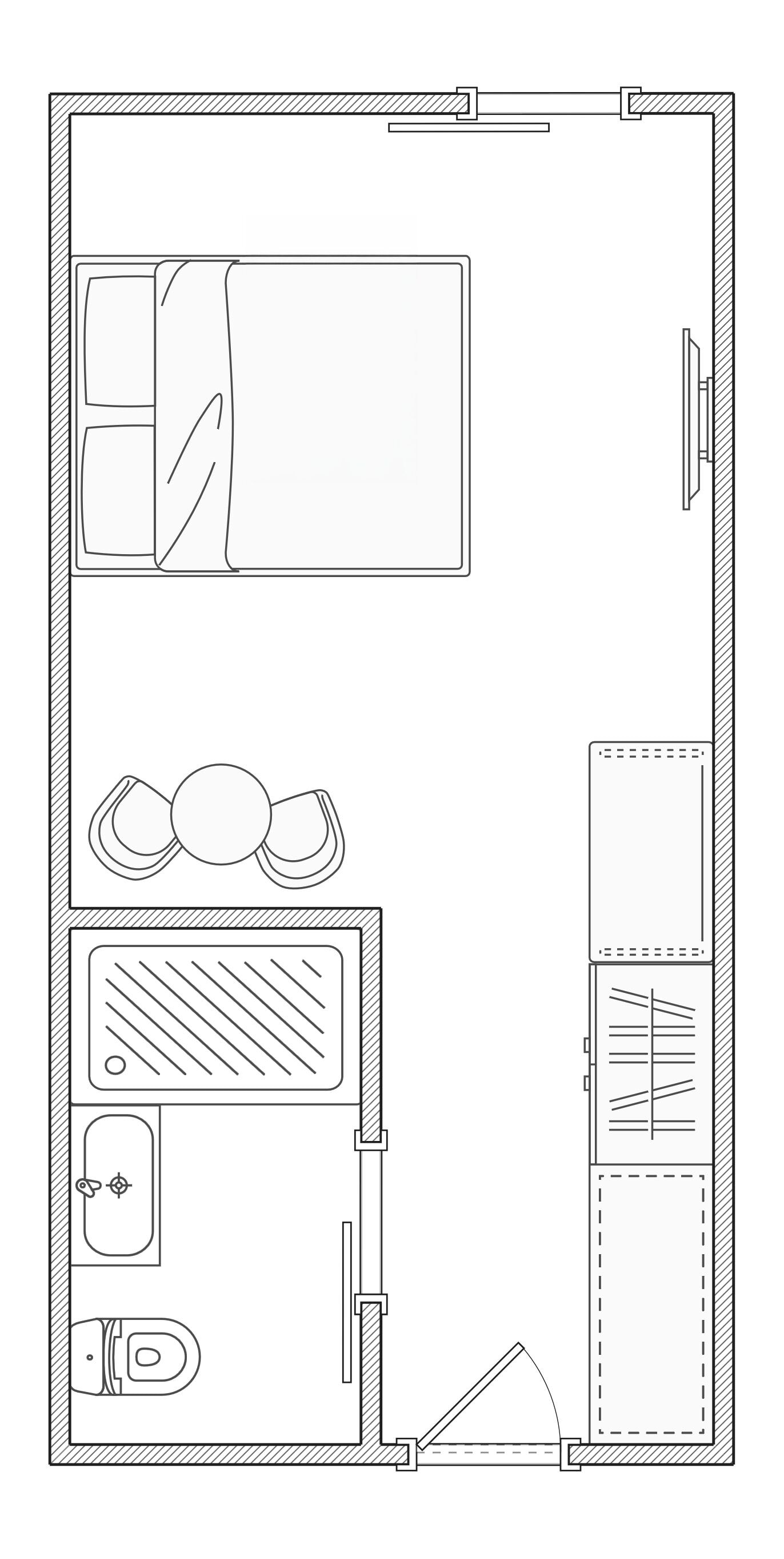 A floor plan with a large central room, a smaller room with a bed, a bathroom, and a kitchen area.