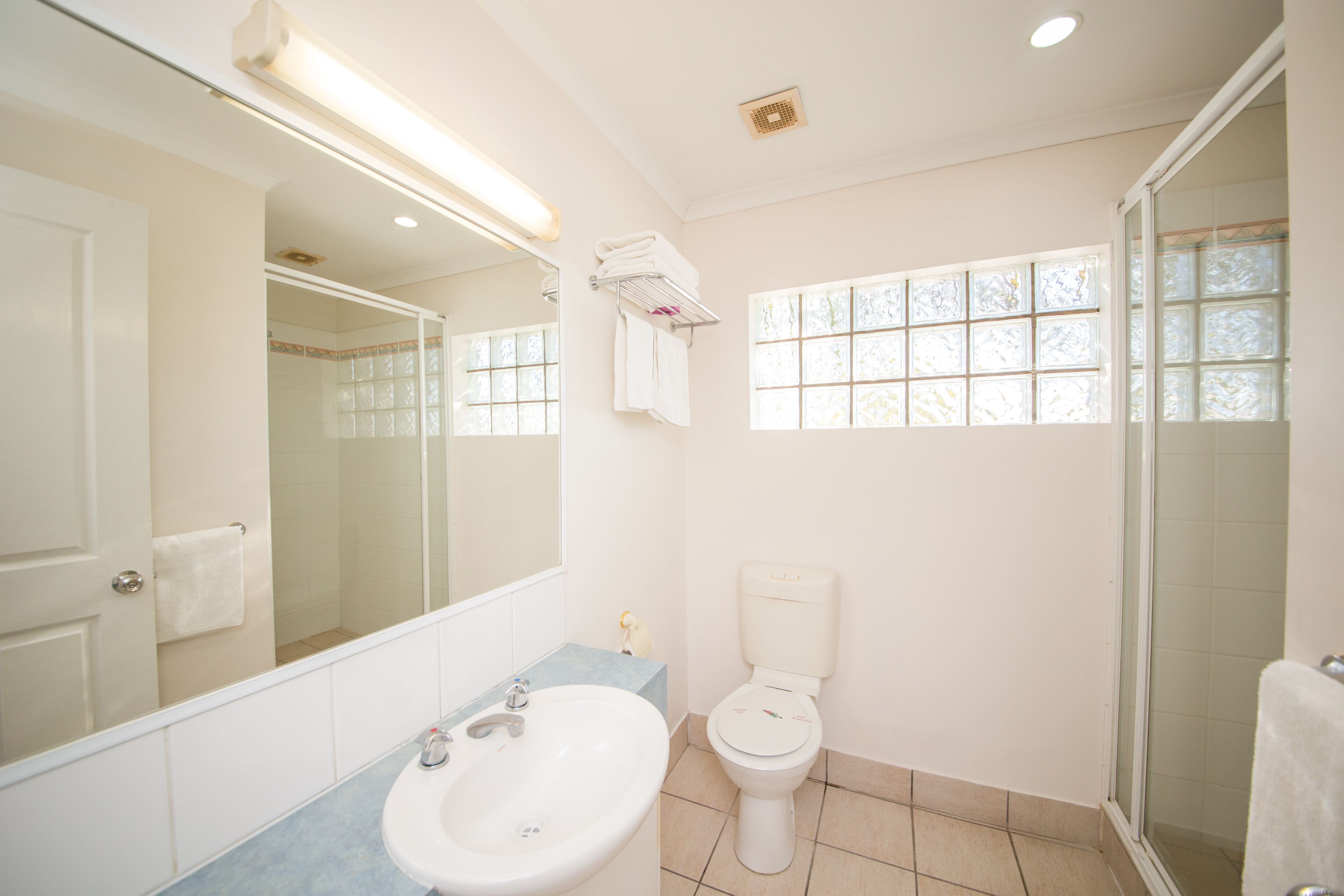 A bathroom with a sink, toilet, and shower.