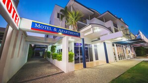 A modern motel with a sign reading "Motel & Apartments" and a visible entrance. - The Cosmopolitan Motel and Serviced Apartments (Rockhampton)