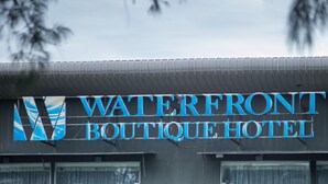 The Waterfront Boutique Hotel with a sign above the entrance, a balcony, and a seafood restaurant below. - WaterFront Boutique Hotel (Port Dickson)