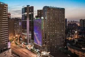 A high-rise building with multiple floors, large windows, and a prominent vertical light display. - Holiday Inn Express Chengdu West Gate by IHG (Chengdu)