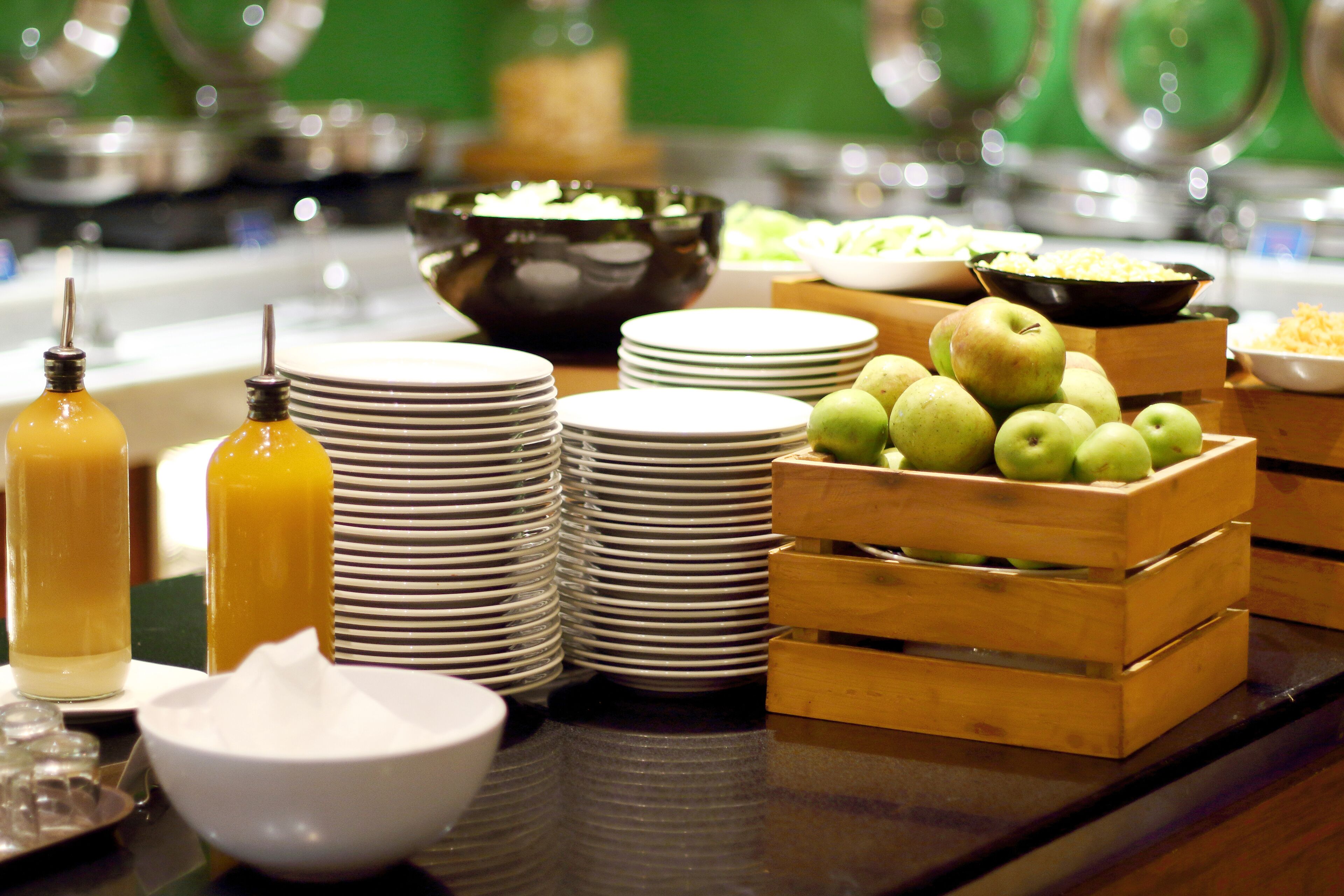 A buffet setup with various food items and dishes.