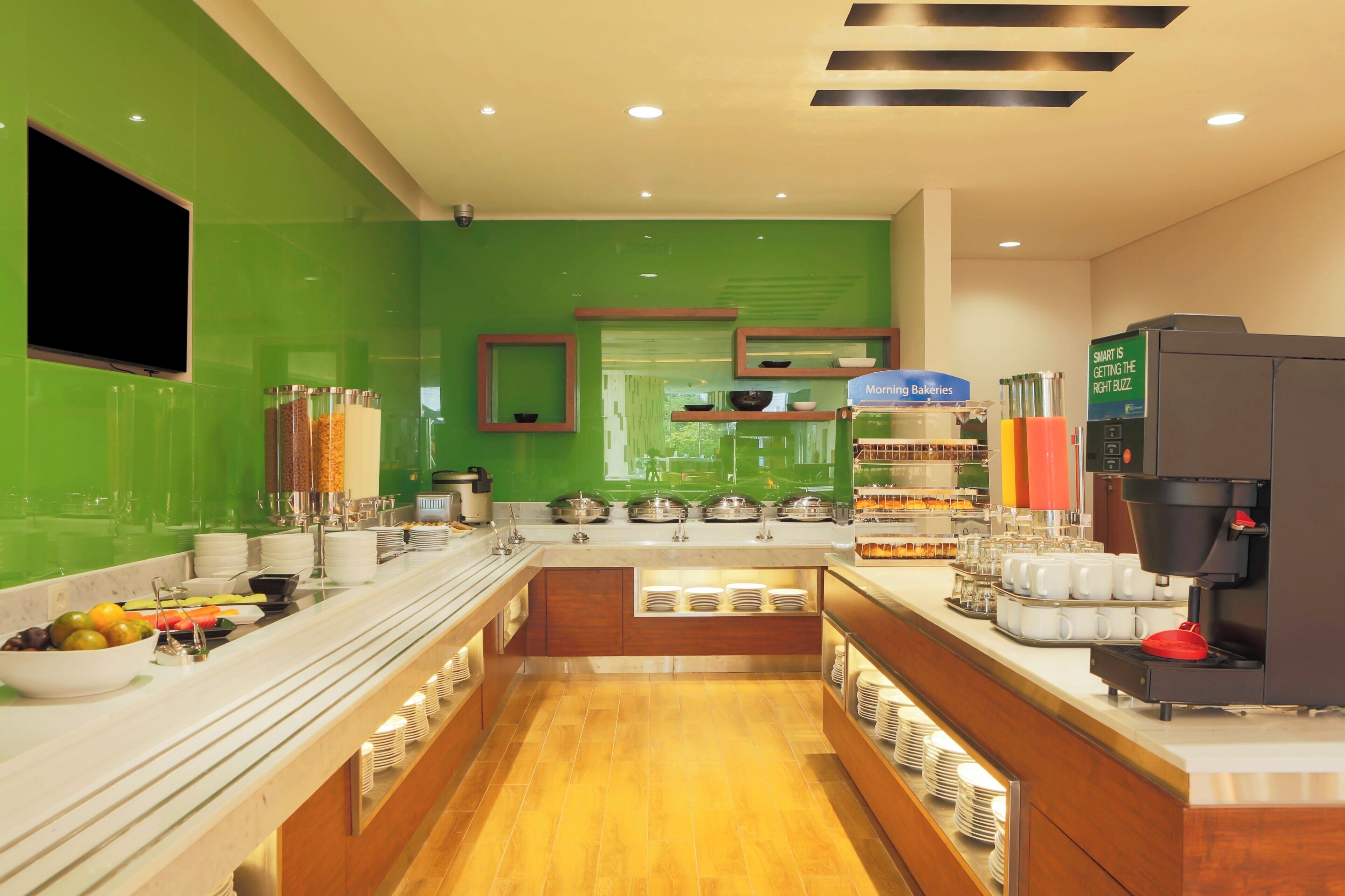 A modern kitchen with a central island, equipped with various appliances and utensils.