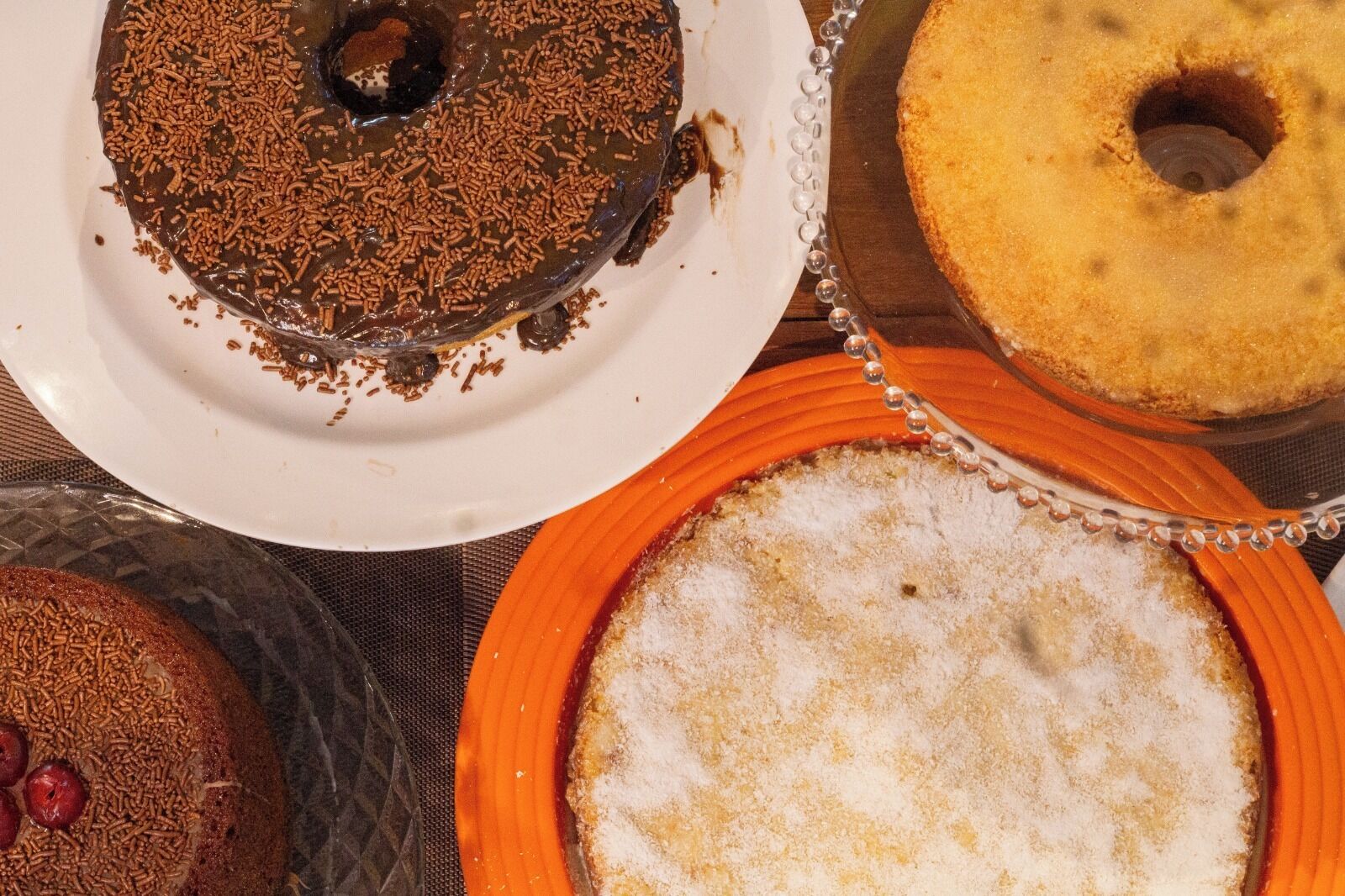 A table with various cakes on plates.