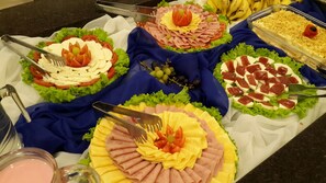 A buffet with various food items including salads, meats, and fruits. - Hotel Ryan (Balneário Camboriú)