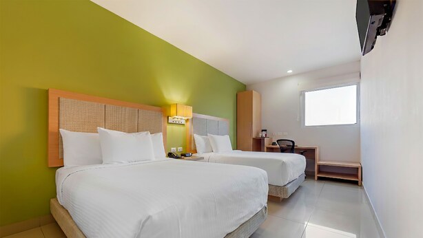 A hotel room with two beds, a desk, a chair, a television, and a window. - Sleep Inn Culiacan (Culiacán)
