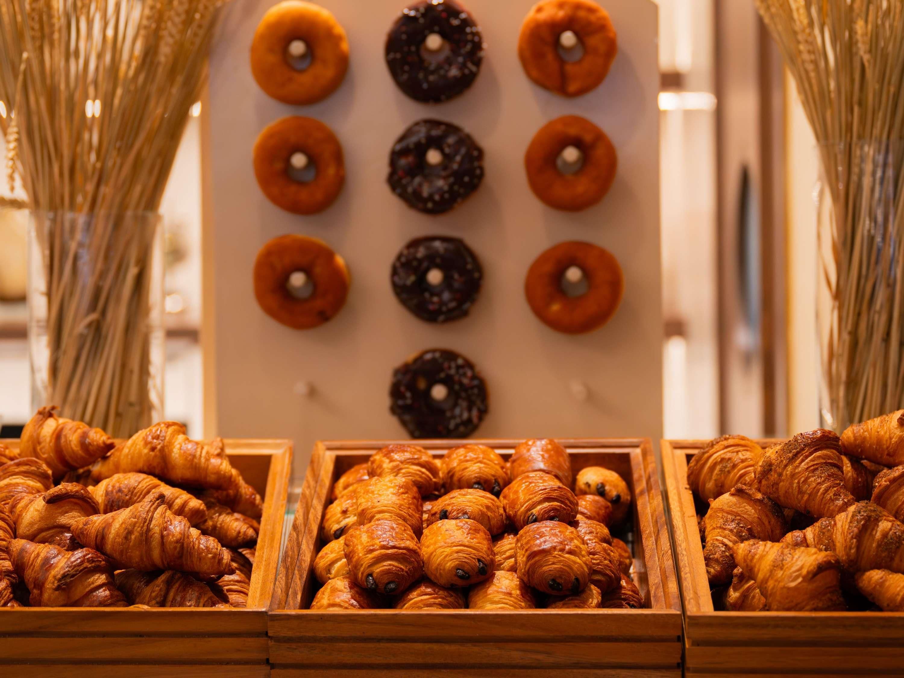 Una bandeja de pasteles que incluye croissants y donas.