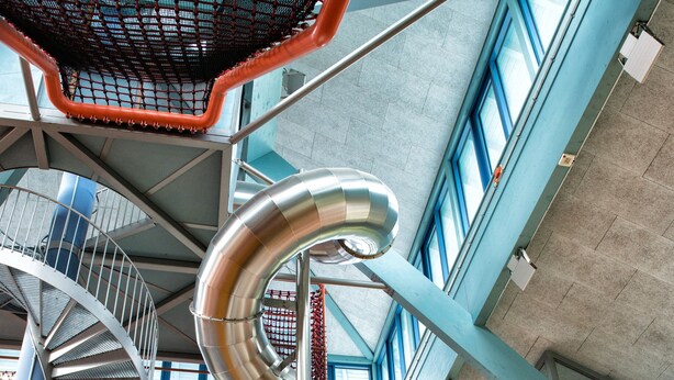 A modern building with a spiral staircase, large windows, and a metal sculpture. - JUFA Hotel Jülich im Brückenkopf-Park (Jülich)