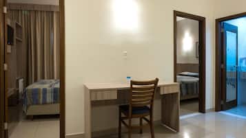 Deluxe Quadruple Room, Multiple Beds | Minibar, in-room safe, desk, laptop workspace