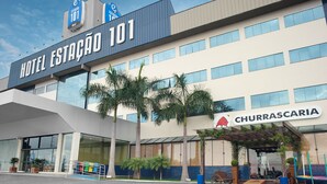 A hotel named "Hotel Estação 101" with a modern design, large windows, and a sign for "Churrascaria" indicating a dining option. - Hotel Estação 101 (Itajai)