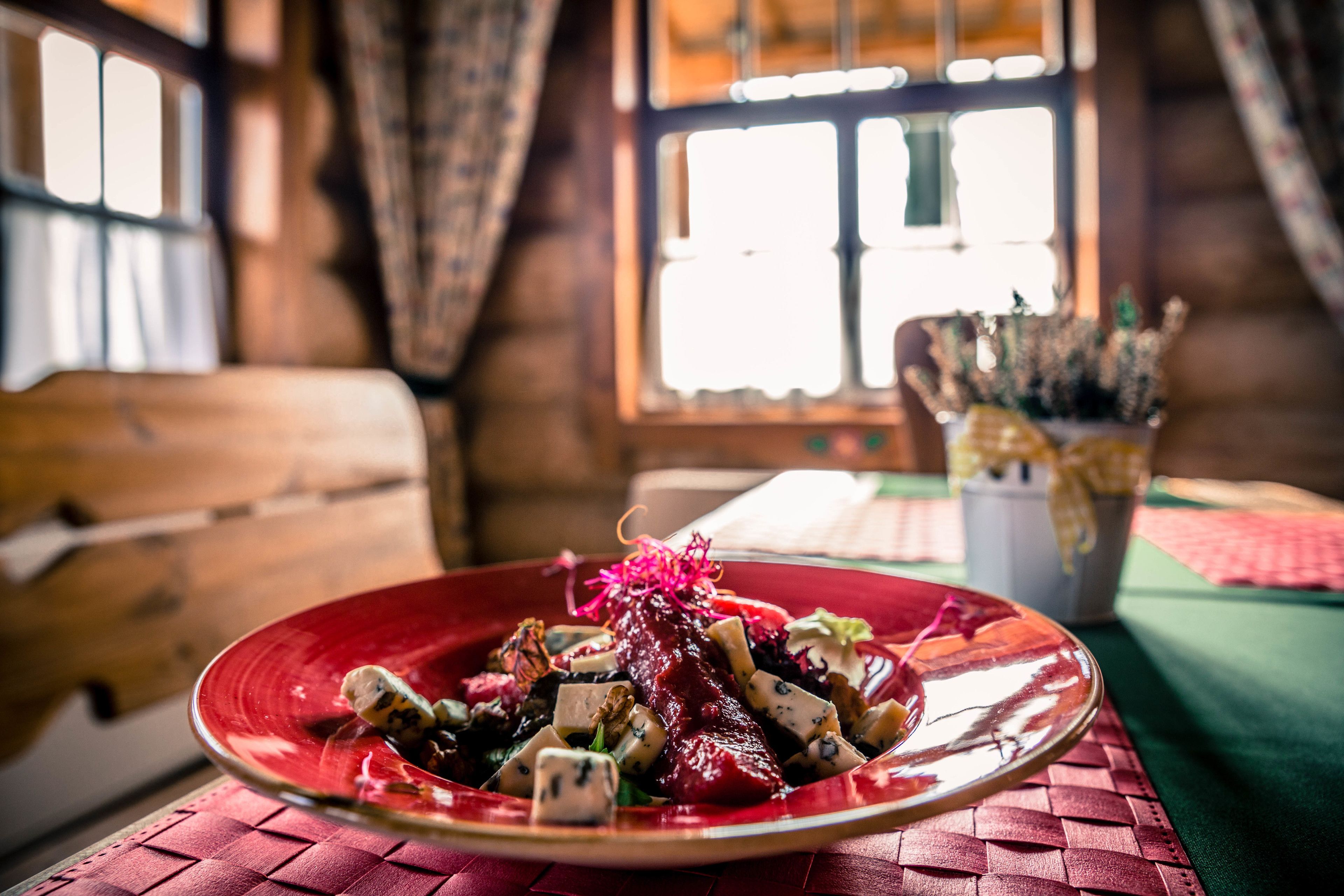 A rustic wooden interior with a dining table set for a meal.