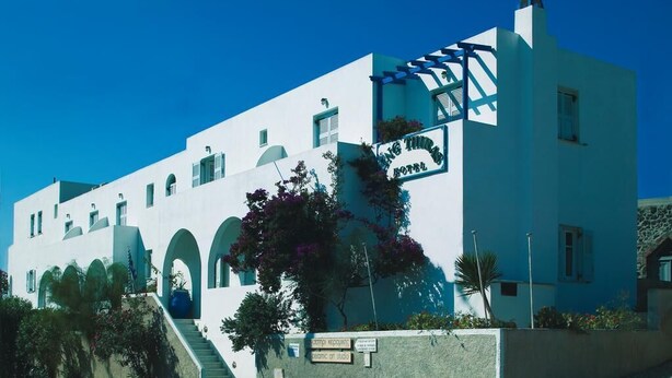 A white building with a sign that reads "Hotel". - King Thiras (Santorini)