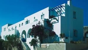 A white building with a sign that reads "Hotel". - King Thiras (Santorini)