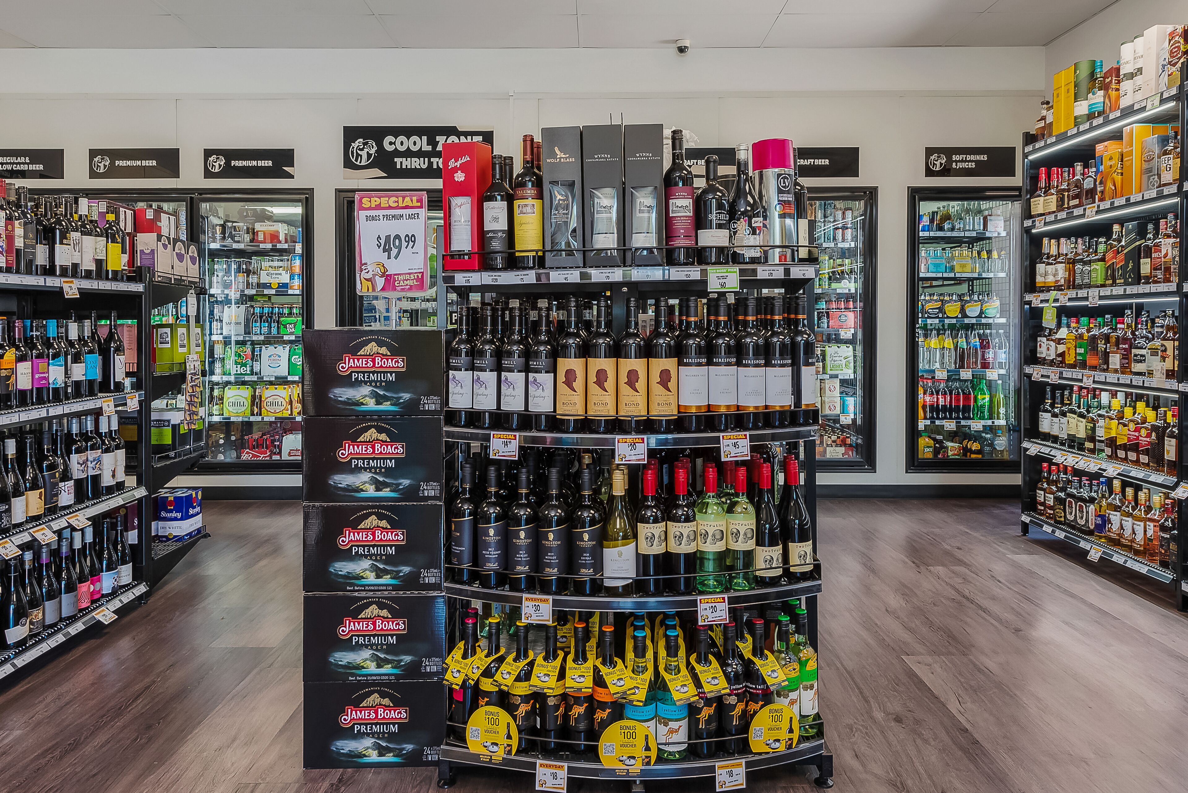 A liquor store with shelves stocked with various bottles and boxes of alcohol.