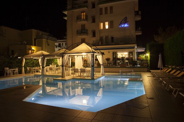 Piscina a l'aire lliure, para-sols i gandules
