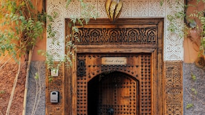 A wooden door with intricate carvings and a sign that reads "Riad Anya." - Riad Anya (Marrakech)