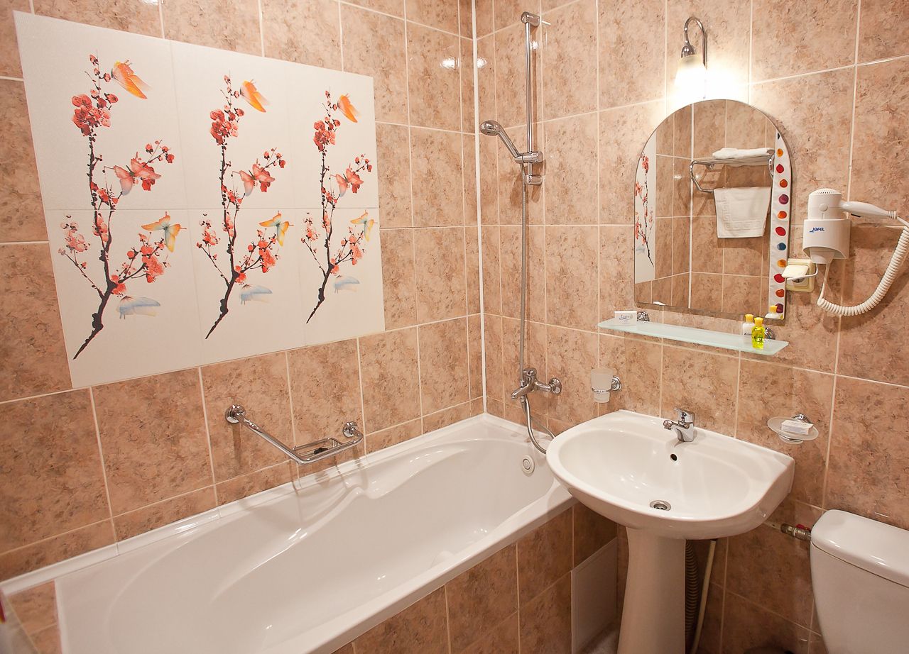 A bathroom with a bathtub, a sink, a toilet, and a shower.