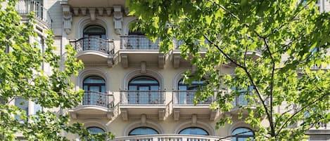 A historic hotel with ornate balconies, large windows, and a classic facade.
