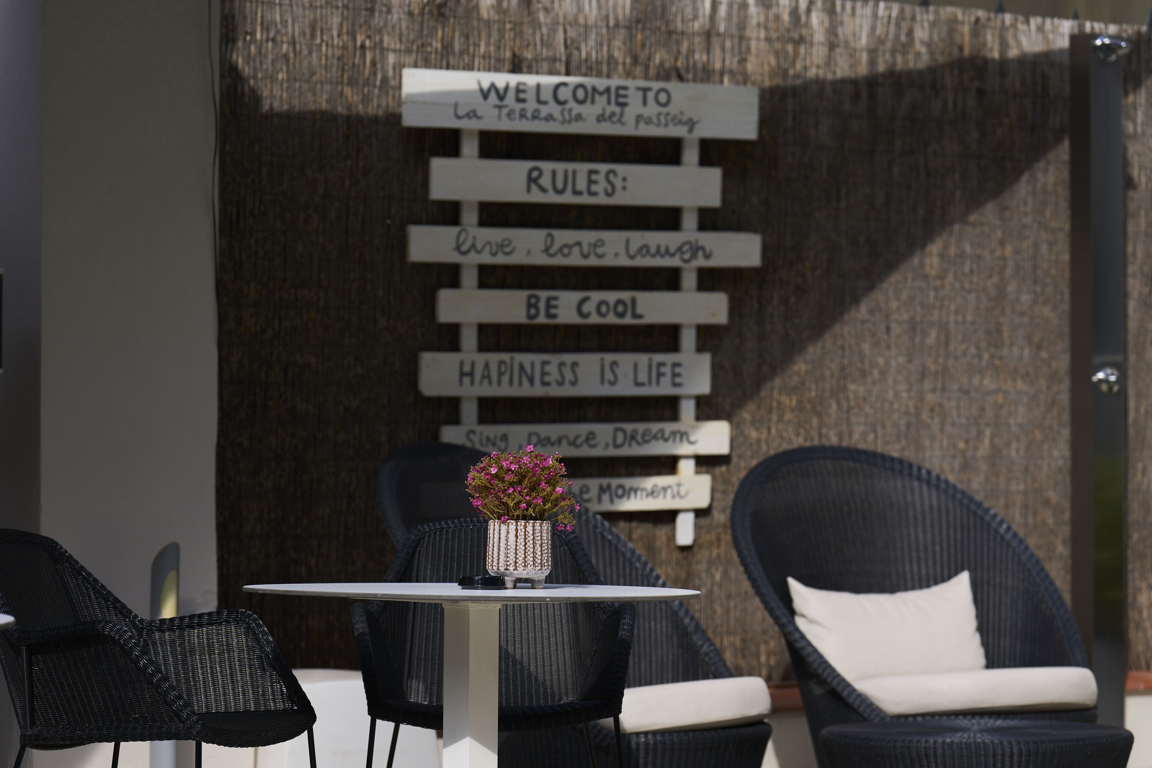 A table with chairs and a sign with motivational phrases.