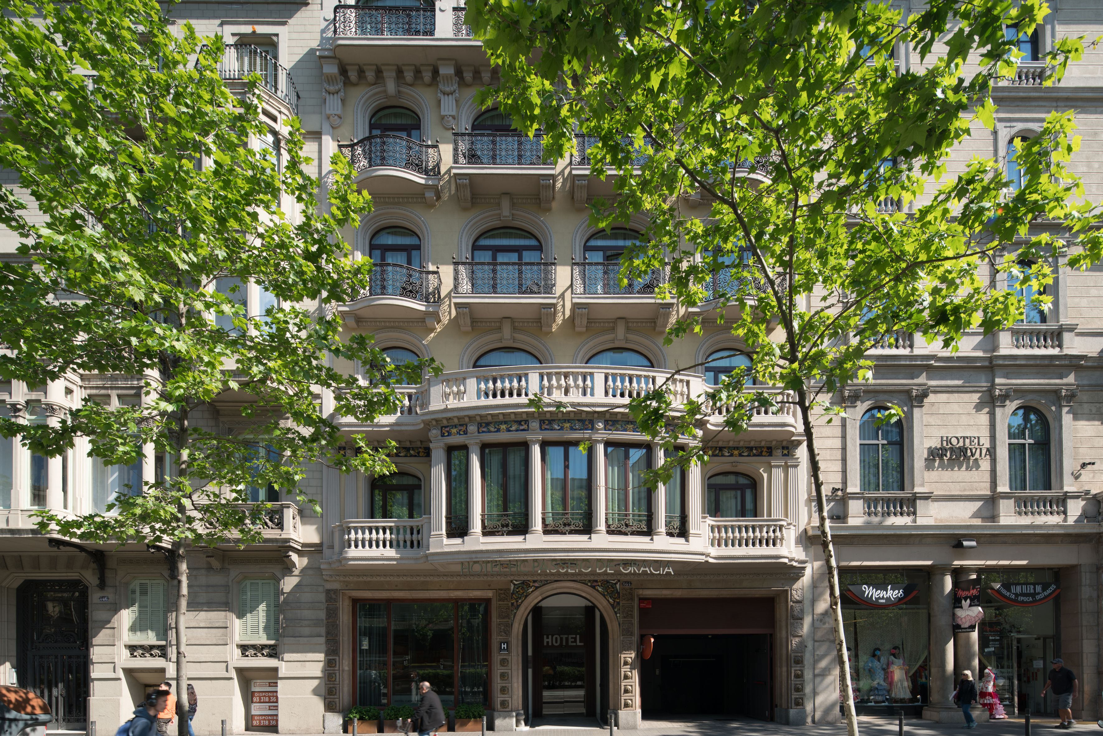 A historic hotel with a classic European architectural style, featuring ornate balconies and large windows.