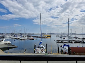 A marina with multiple boats docked, a clear sky, and calm water. - Hotel Galion (Gdansk)