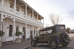 A vintage car parked in front of a white building with a balcony. - The Martinborough Hotel (Martinborough)