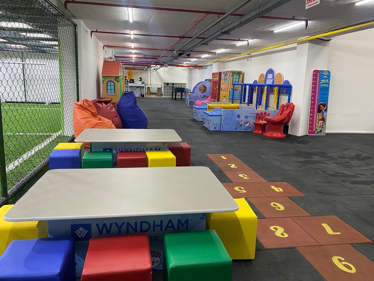 A children's play area with colorful play structures and a hopscotch game.