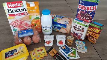A variety of food items including Herta Bacon, Nestle Crunch, and Lipton tea.