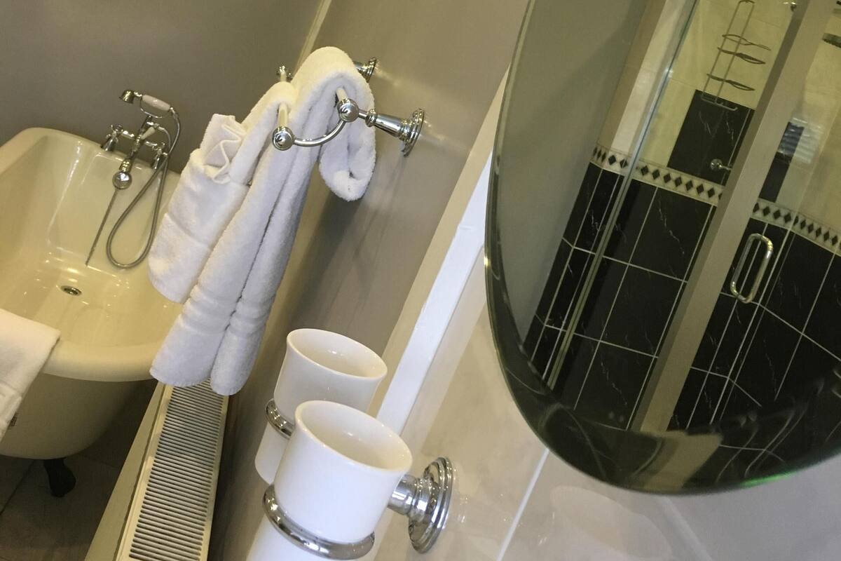 A bathroom with a bathtub, a shower, and a toilet.