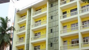 A multi-story hotel with yellow balconies and a ground-level entrance. - Vasco Residency (Marmagao)