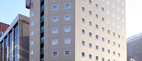 A tall, rectangular hotel building with a flat facade and numerous windows.