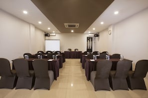 Conference room with a long table and comfortable seating for meetings and presentations.