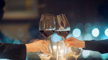A table with wine glasses and a red object, possibly a fruit.