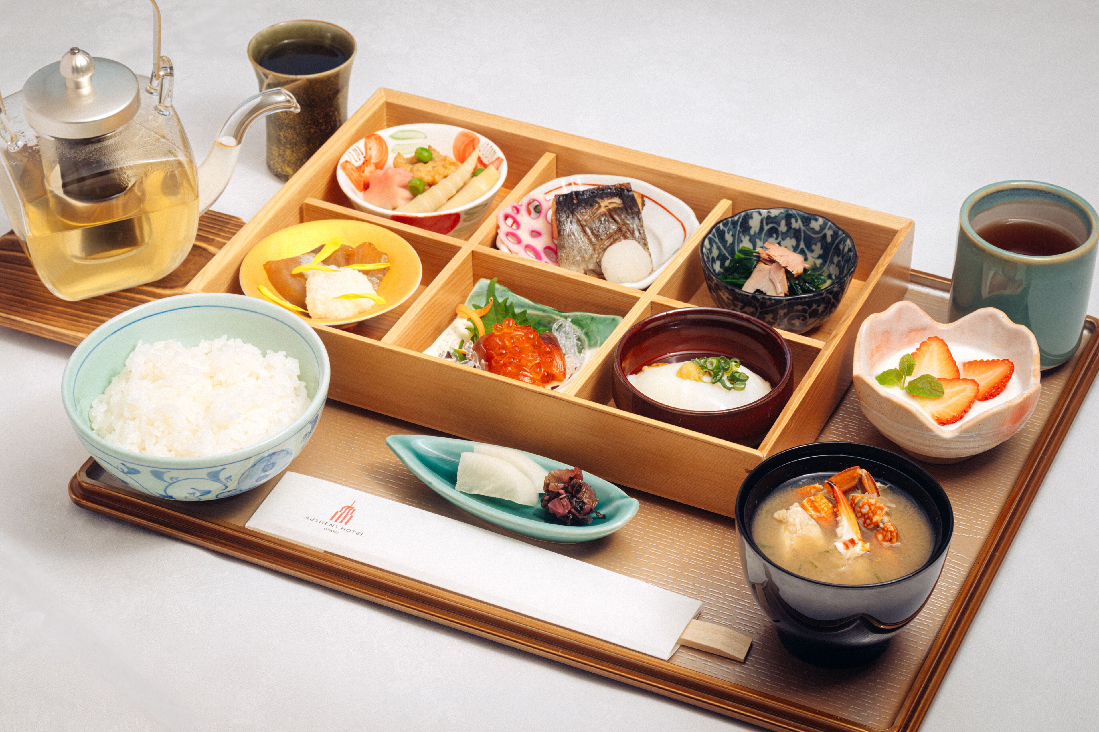 A traditional Japanese meal setup with various dishes and a teapot.