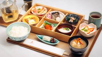 A traditional Japanese meal setup with various dishes and a teapot.