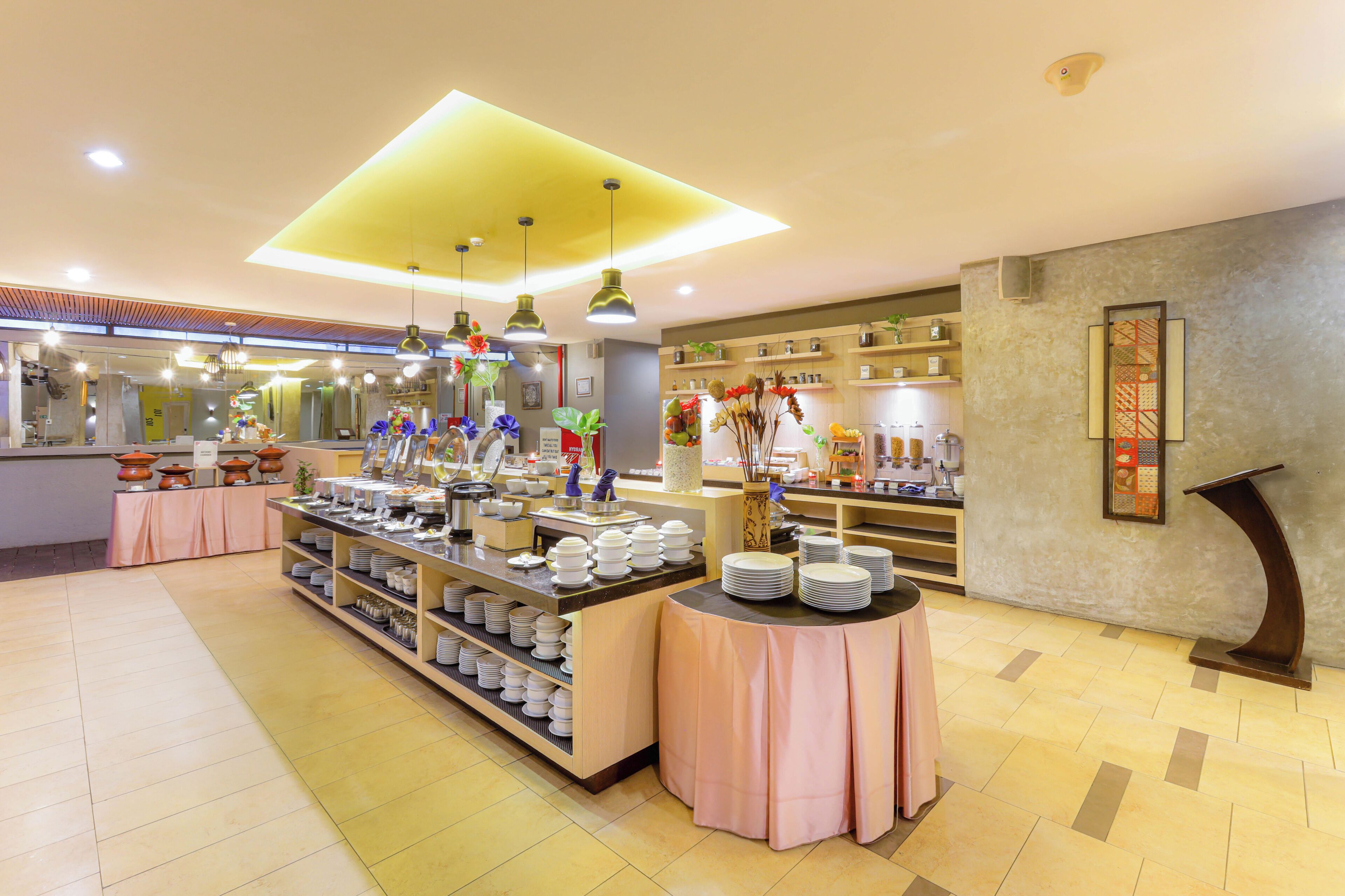 A buffet setup with multiple serving stations, a central display area, and a variety of food items.