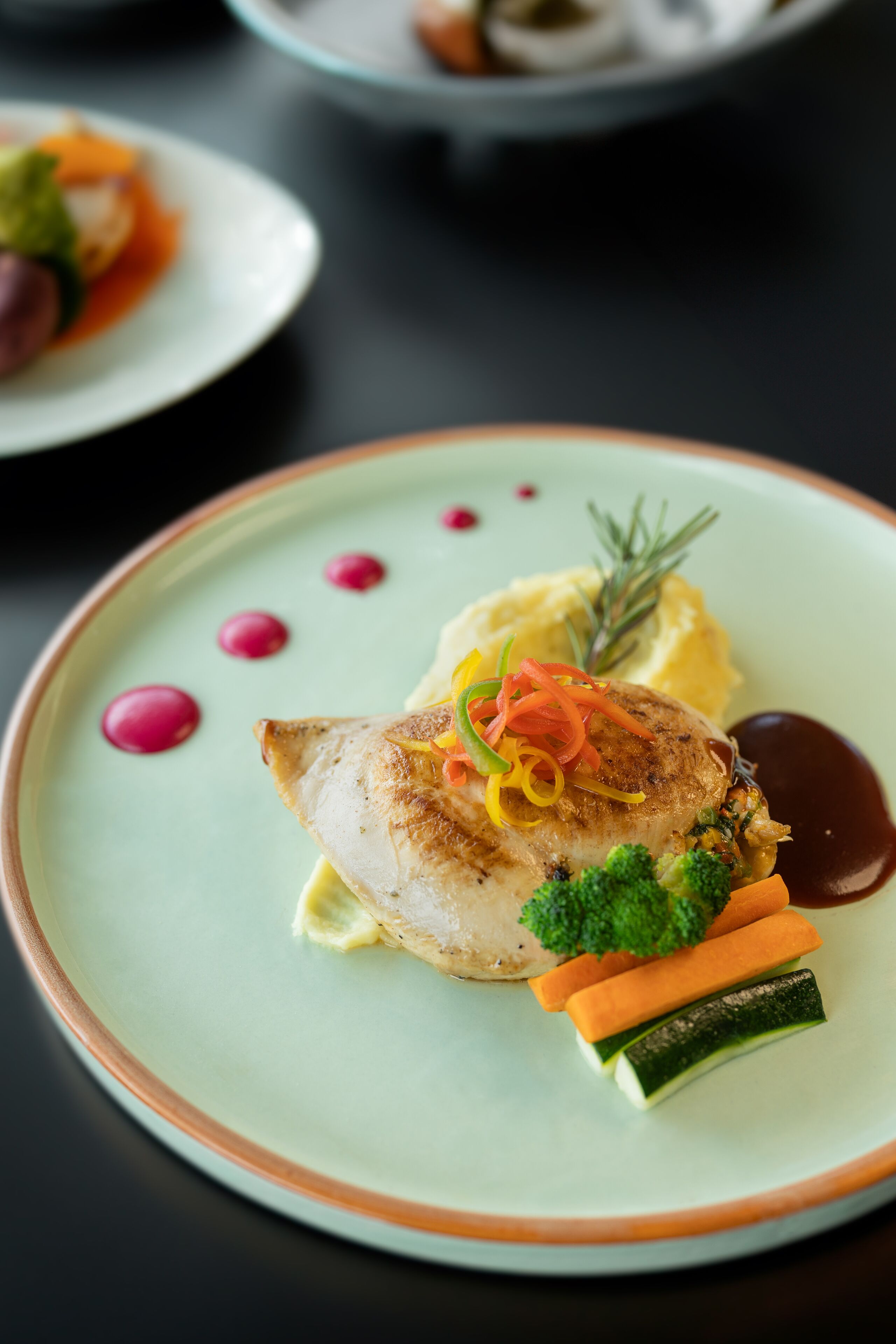 A plate with a piece of fish, mashed potatoes, and vegetables.