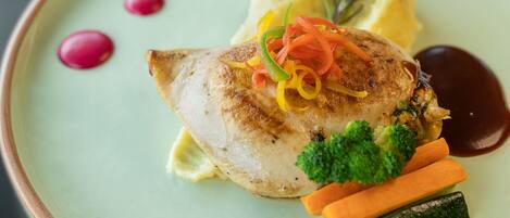 A plate with a piece of fish, mashed potatoes, and vegetables.